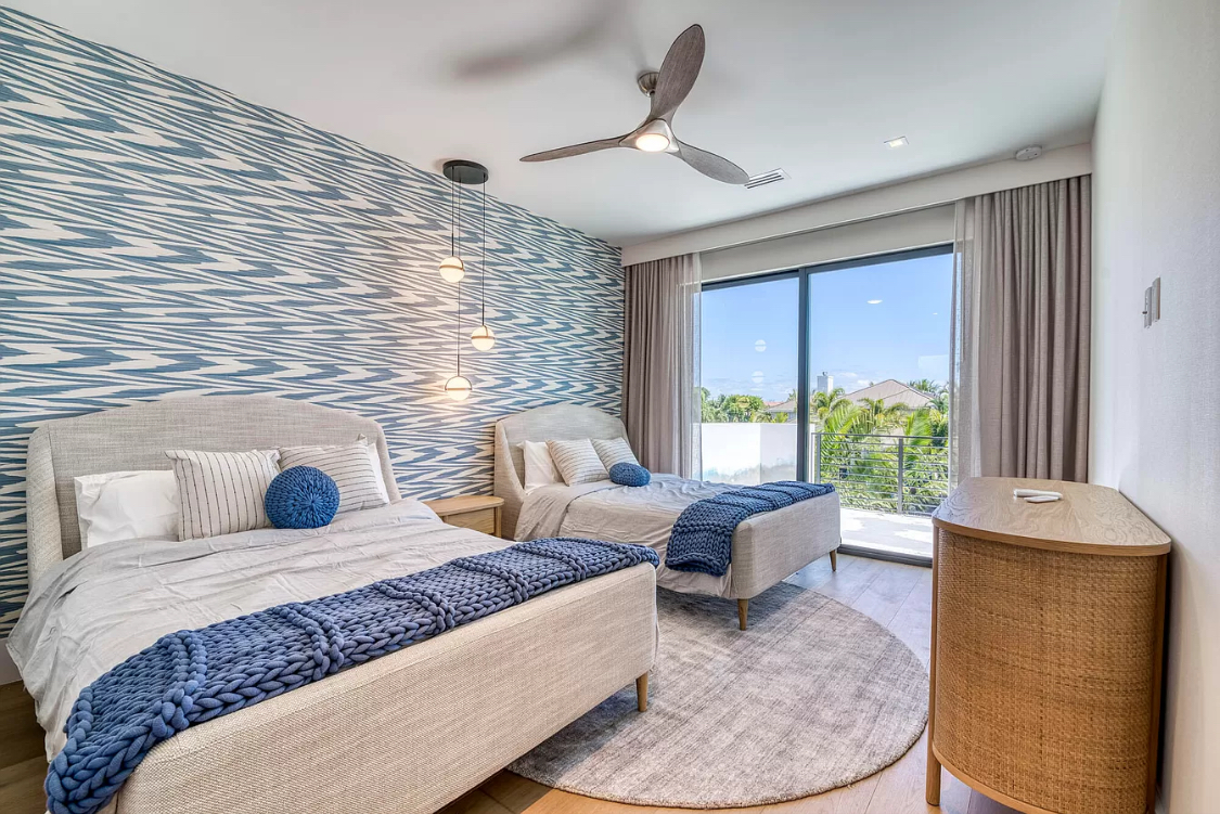 West Palm Beach estate twin bedroom with blue wallcovering and drapery