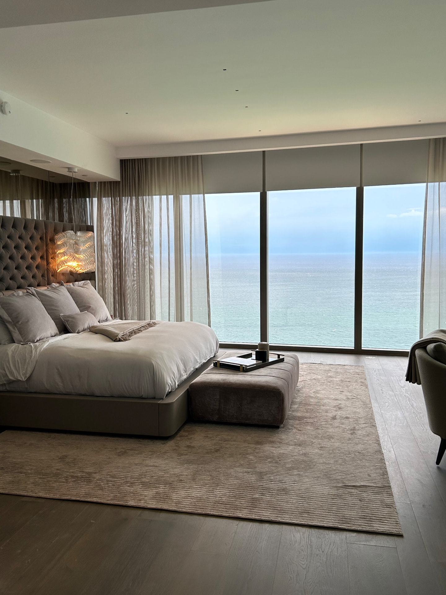 Estate at Acqualina bedroom with sheers and partially lowered room-darkening shades