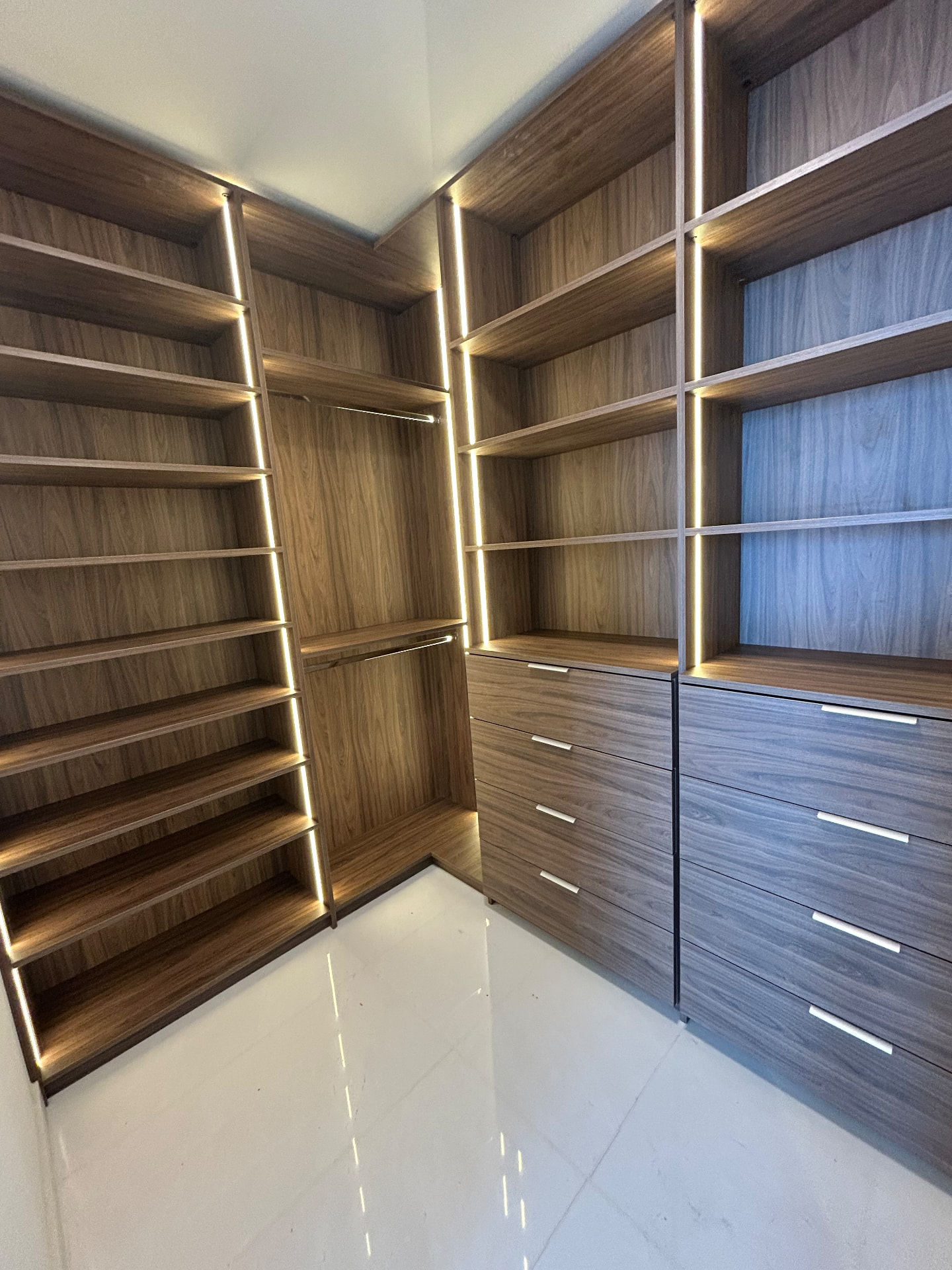 Aston Martin Residences walnut walk-in closet with LED lighting