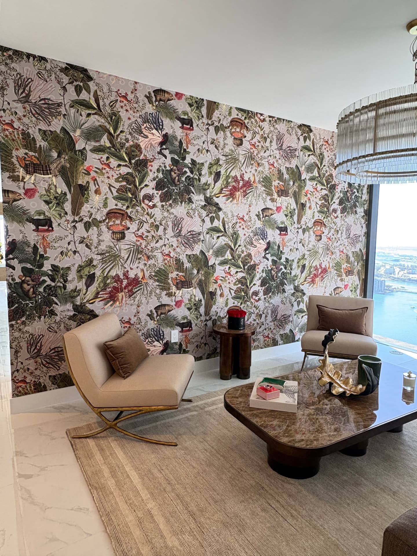 Aria Reserve living room with botanical mural wallcovering and bay view