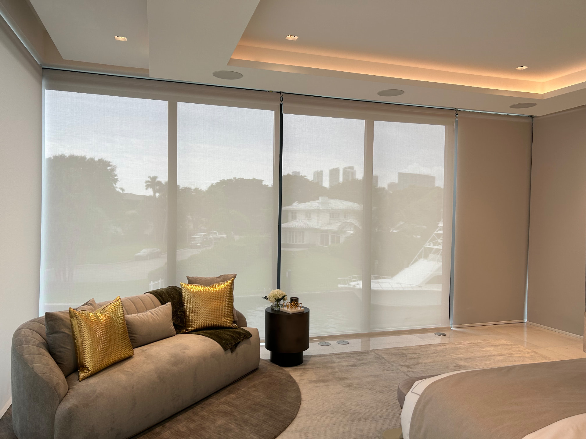 Missoni Baia primary suite with motorized solar shades on waterfront glass