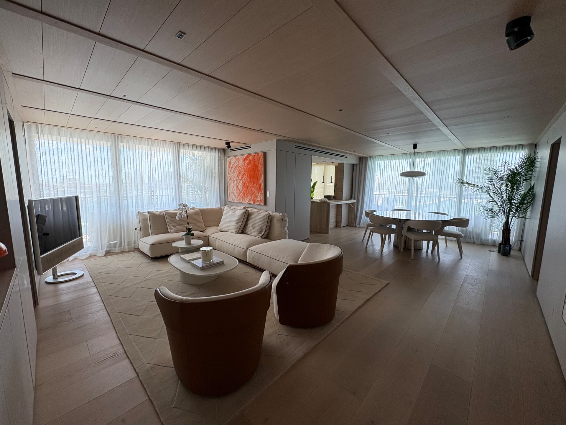 Aria Reserve open living and dining area with full-height sheer drapery