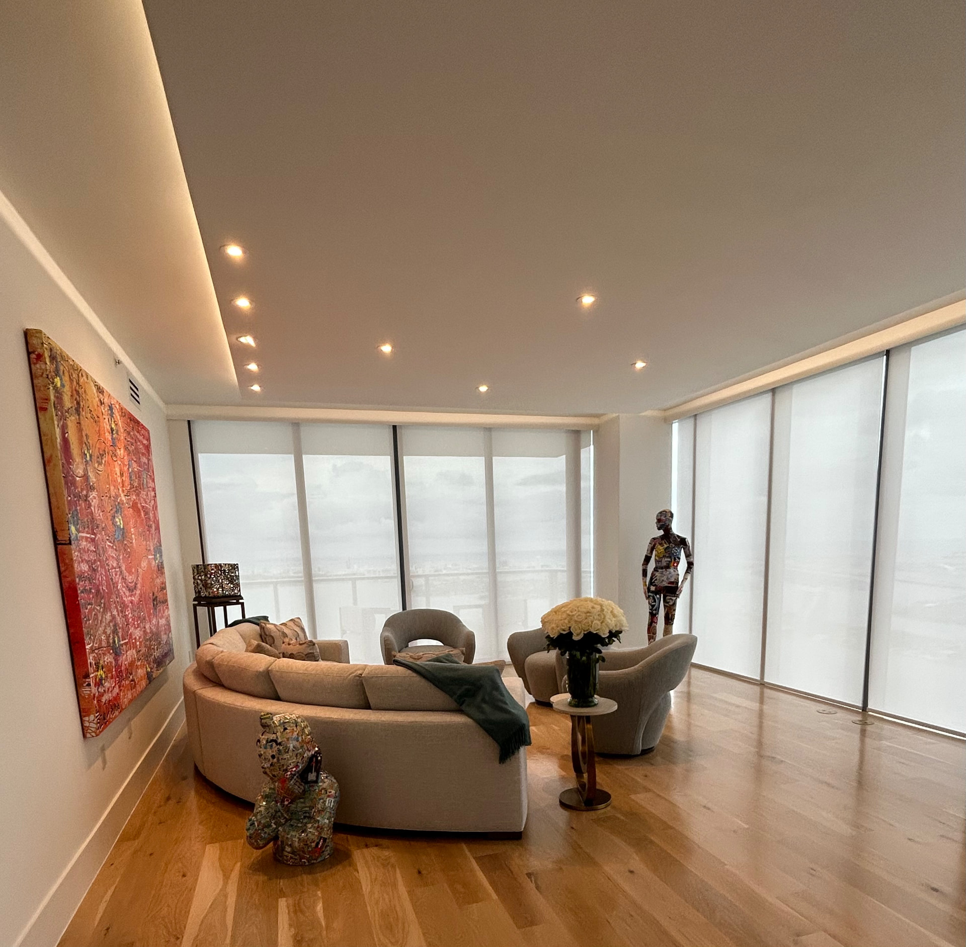 Missoni Baia living room with solar roller shades, curated art and white roses