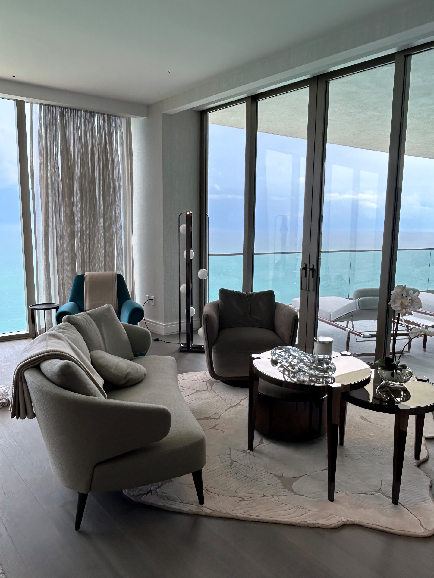 Estate at Acqualina living room with sheer drapery and a solar shade facing the ocean