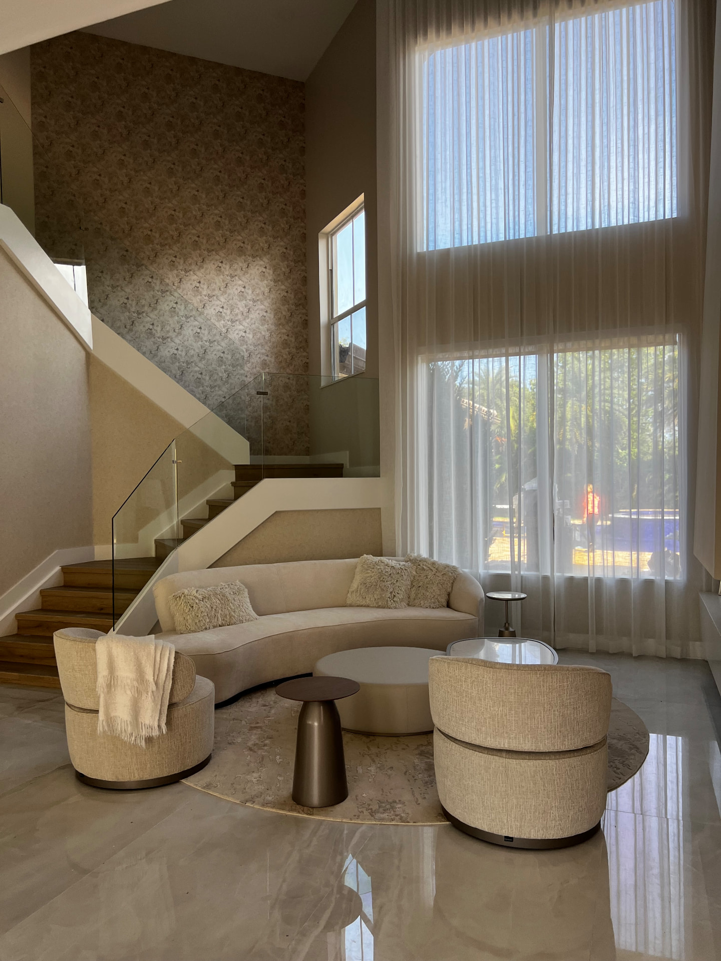 Pembroke Pines stair lounge with double-height sheers and patterned wallcovering