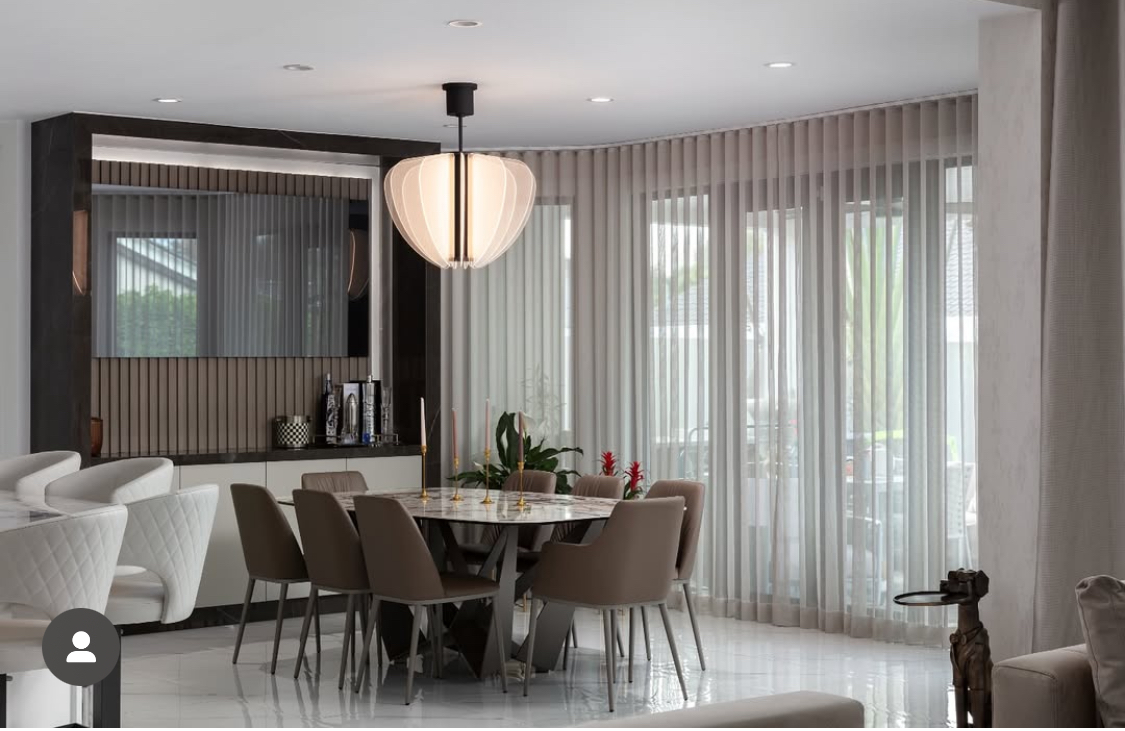 Doral Isles dining room with full-height sheer window treatments