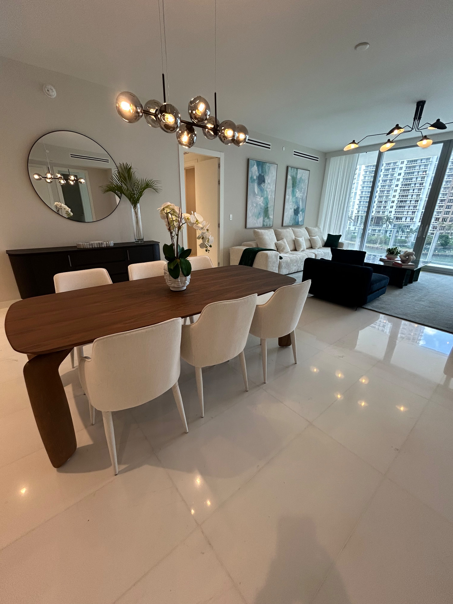 Aston Martin Residences open dining and living area with sheer drapery