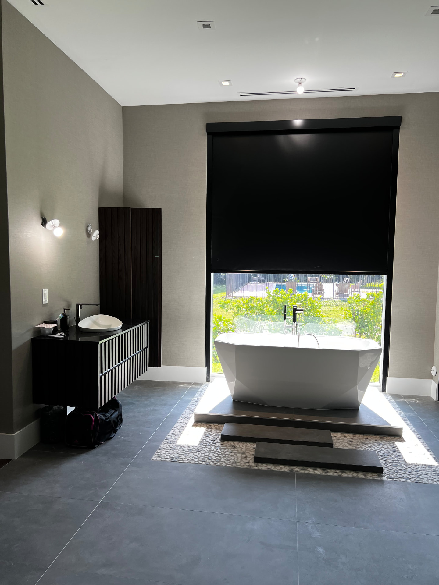Southwest Ranches primary bath with a blackout roller shade and textured wallcovering