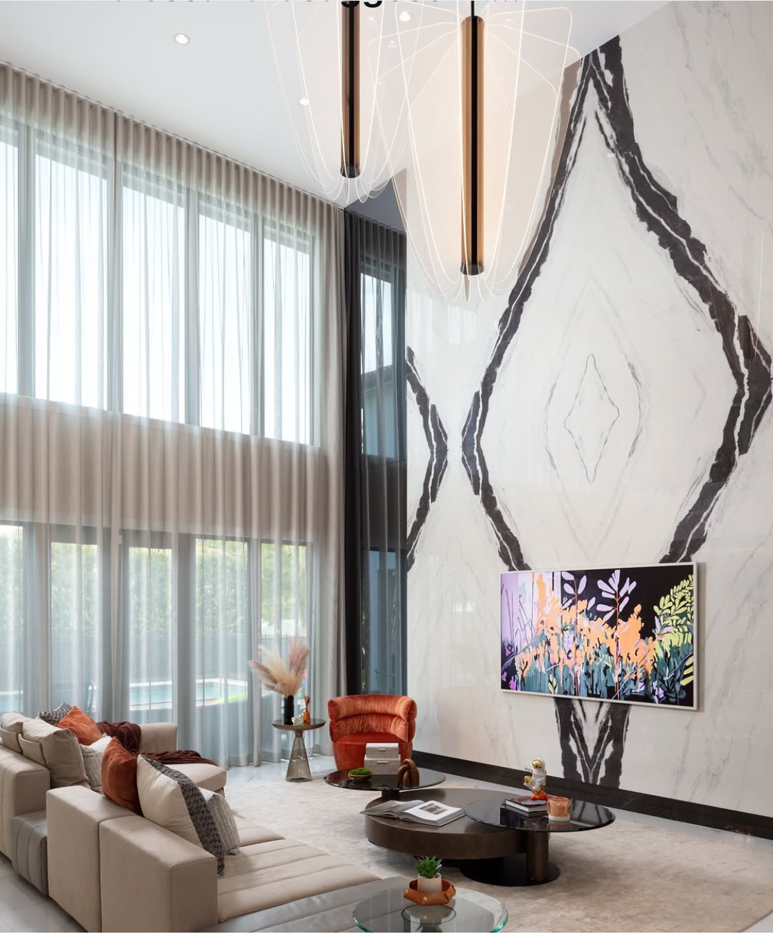 Doral Isles double-height living room with floor-to-ceiling sheer drapes