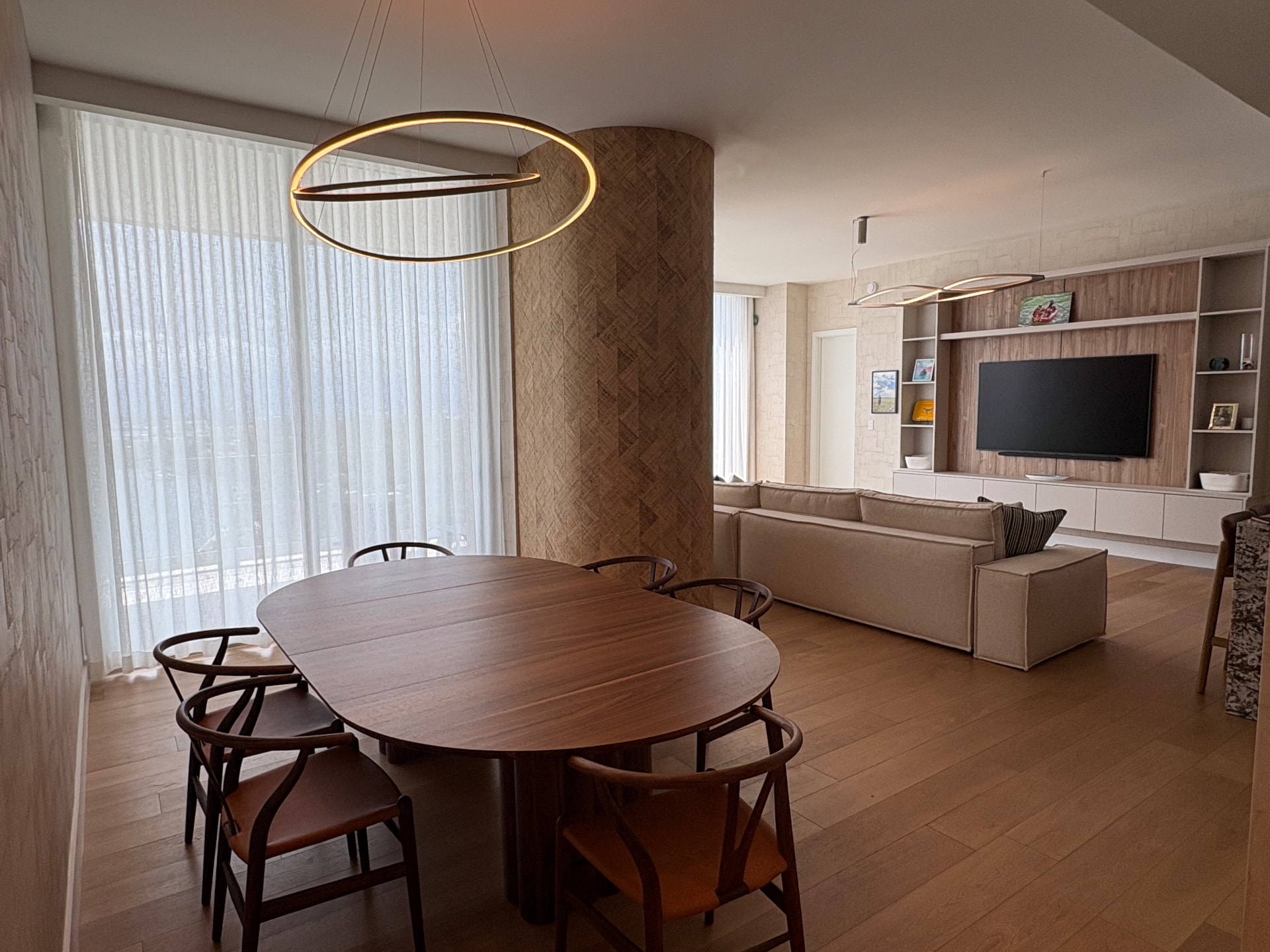UNA Residences open-plan interior with motorized drapes wallpaper and WallTV