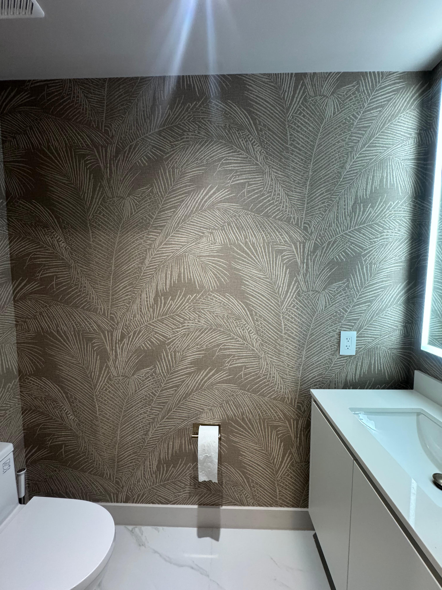 Detail of palm leaf wallcovering in Aria Reserve powder room