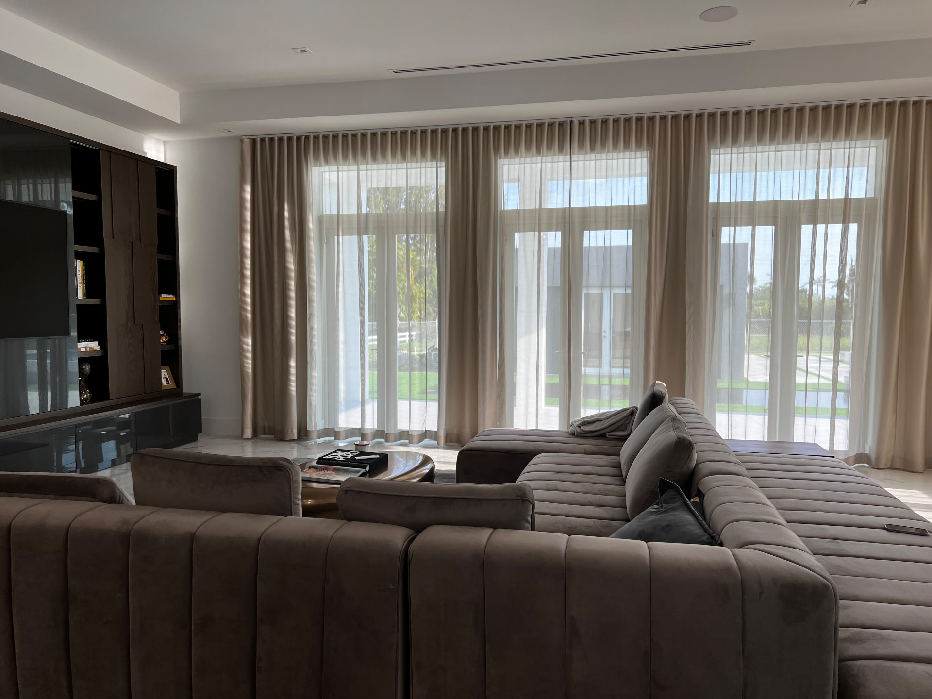 Southwest Ranches family room with layered ripple fold sheer and opaque drapery