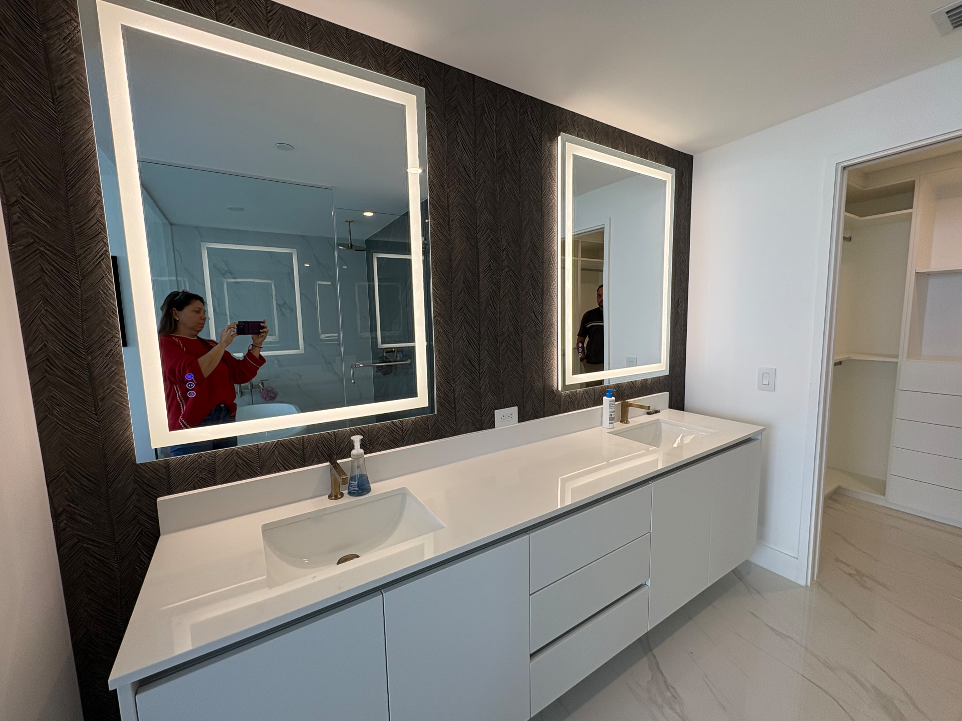 Aria Reserve double vanity with dark textured wallcovering