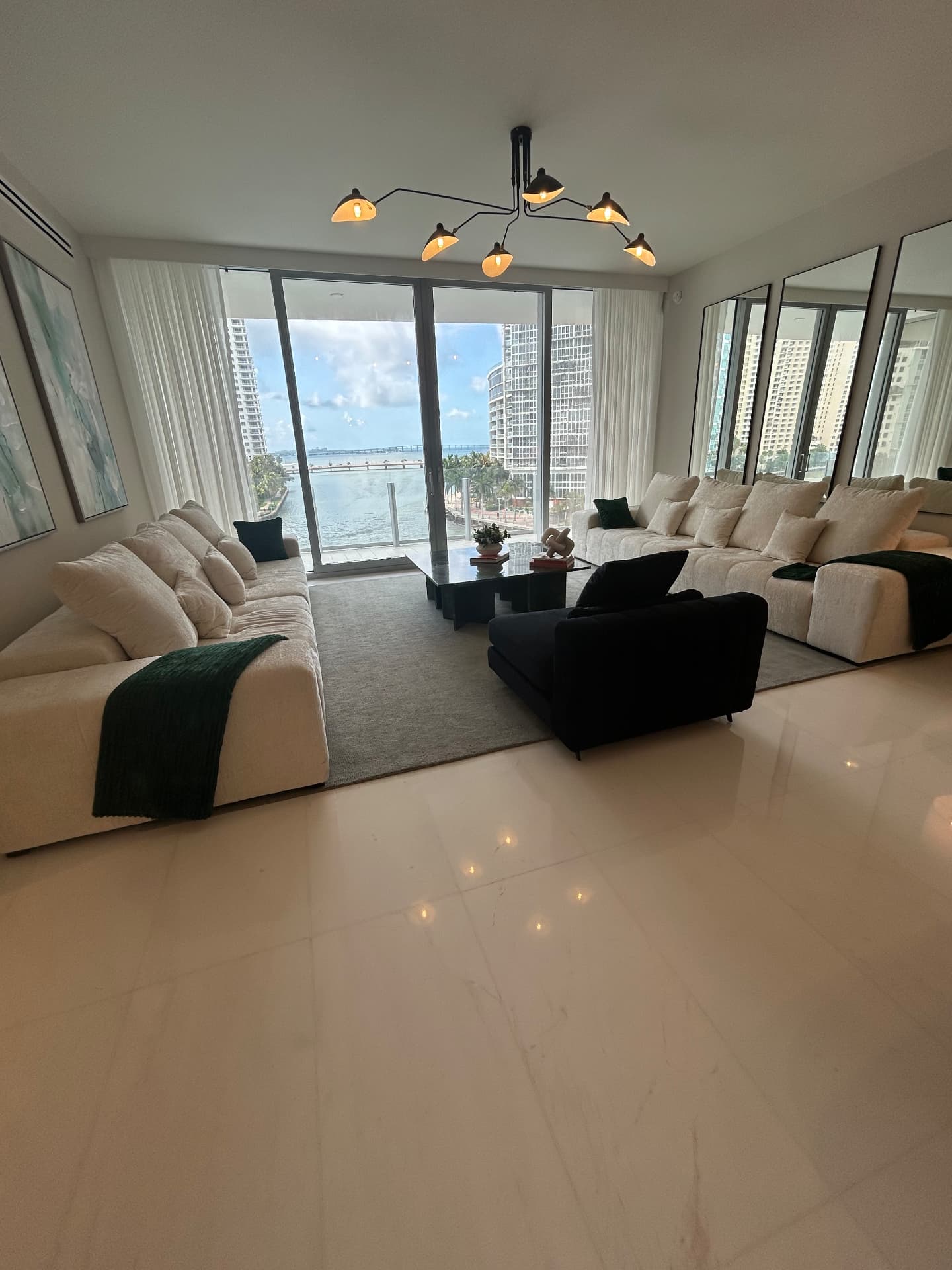 Aston Martin Residences living room with full-height sheer drapery and bay view