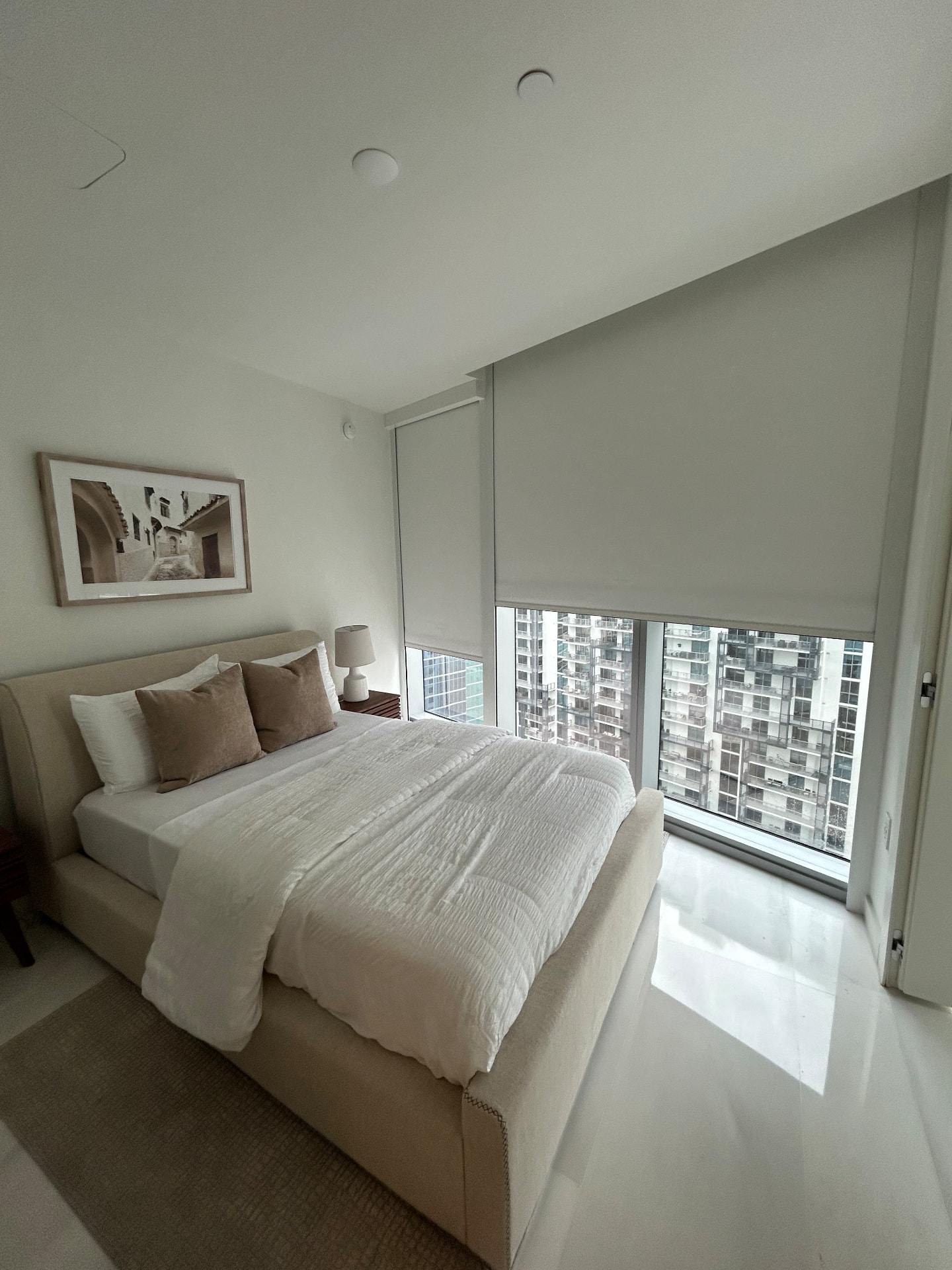 Aston Martin Residences guest bedroom with motorized room-darkening shades