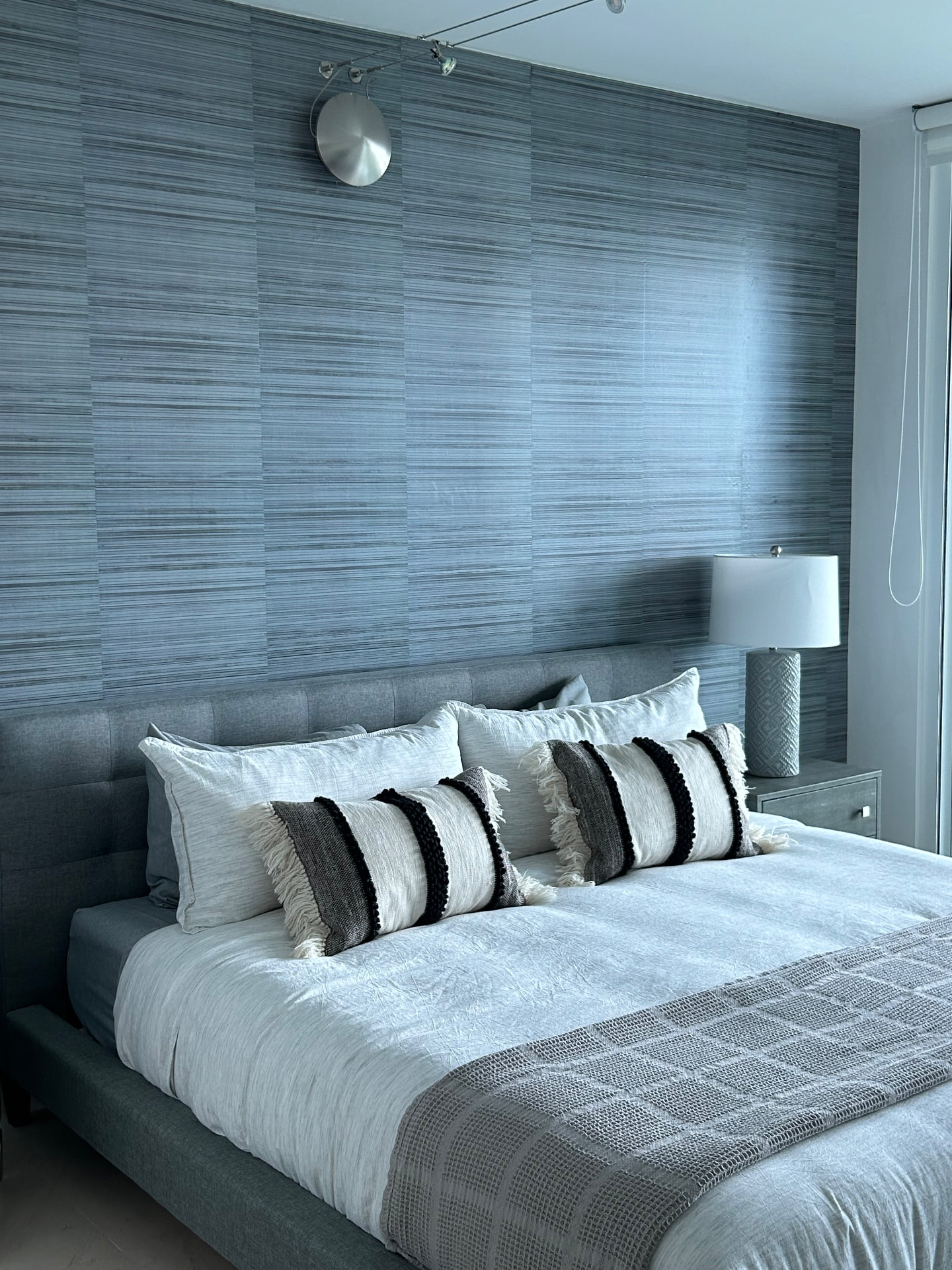 Missoni Baia primary bedroom with grasscloth wallcovering behind the bed